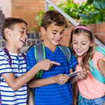 3 kids looking at the cell phone